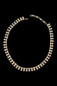 Vertical front view of 1950s vintage gold tone double row iridescent round holographic rhinestone adjustable choker necklace.