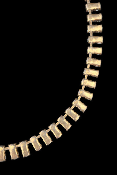 Detail view of 1950s vintage gold tone double row iridescent round holographic rhinestone adjustable choker necklace. Showing a close-up of the back of the gold tone setting.