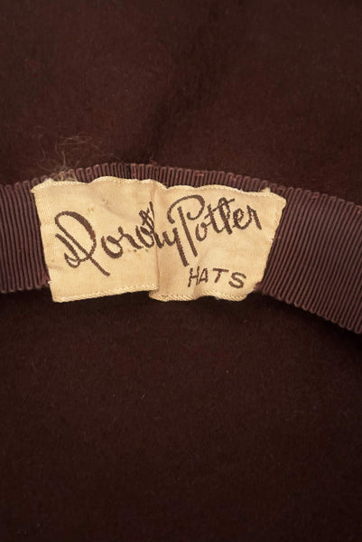 Detail view of 1940s vintage chocolate brown felt wide brim saucer hat trimmed in matching braid, by Dorothy Potter. Showing the Dorothy Potter Hats label.