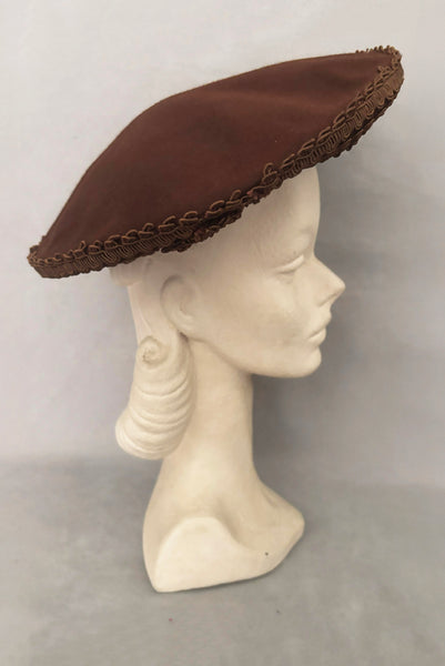 Vertical side view of 1940s vintage chocolate brown felt wide brim saucer hat trimmed in matching braid, by Dorothy Potter.