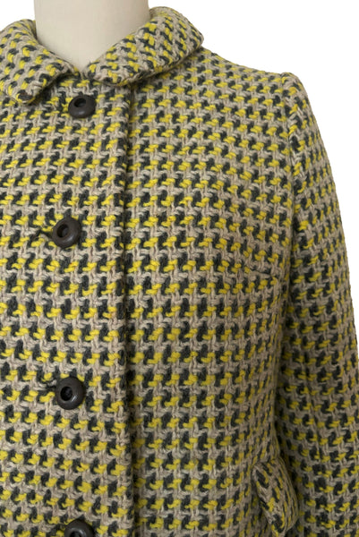 Detail view of 1960s vintage citron yellow, gray, and white bracelet sleeve, knee length wool coat, by Paul Blumenstein, size small to medium. Showing the collar and gray plastic buttons.