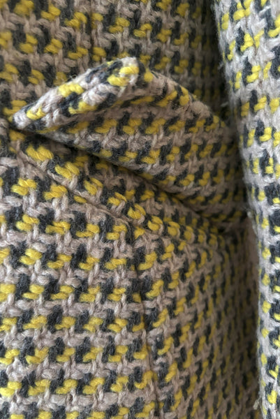 Detail view of 1960s vintage citron yellow, gray, and white bracelet sleeve, knee length wool coat, by Paul Blumenstein, size small to medium. Showing the pocket flaps.