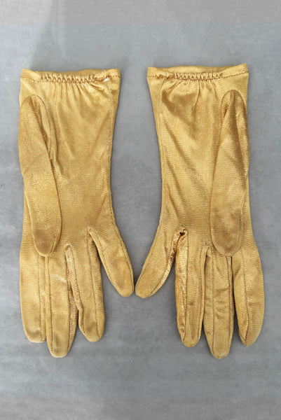 Vertical back view of 1950s vintage wrist length metallic gold nylon gloves. Approximately size 5.