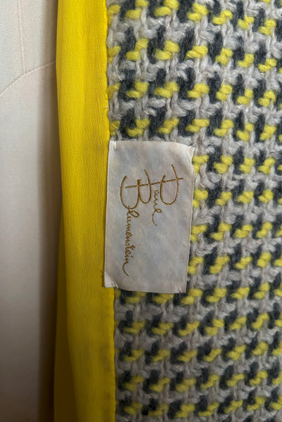 Interior detail view of 1960s vintage citron yellow, gray, and white bracelet sleeve, knee length wool coat, by Paul Blumenstein, size small to medium. Showing the Paul Blumenstein label.