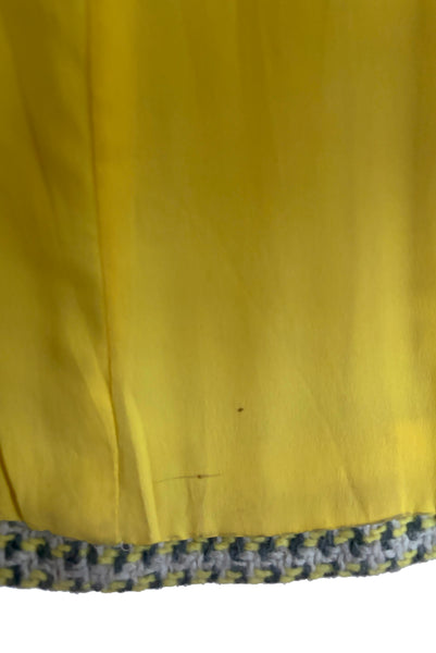 Interior detail view of 1960s vintage citron yellow, gray, and white bracelet sleeve, knee length wool coat, by Paul Blumenstein, size small to medium. Showing some spots on the lining.