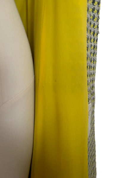 Interior detail view of 1960s vintage citron yellow, gray, and white bracelet sleeve, knee length wool coat, by Paul Blumenstein, size small to medium. Showing some spots on the lining.