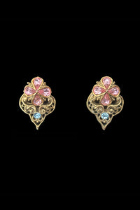 Vertical front view of 1990s vintage blue and pink Floral rhinestone gold tone filigree pierced stud earrings.
