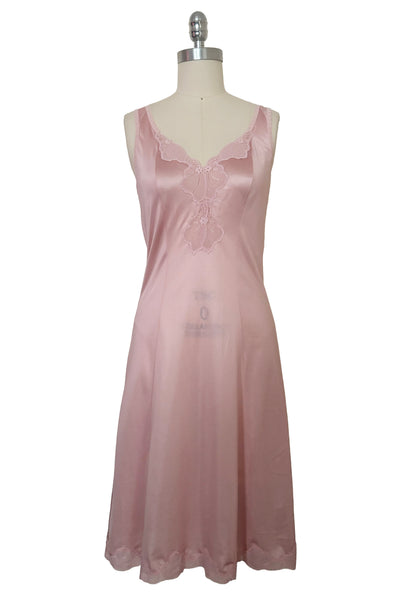 Front view of 1970s vintage blush pink nylon tricot floral lace trimmed nightgown by Maidenform, size extra small to small. Curved V-neckline, sleeveless, scoop back, princess seams, knee length hem.