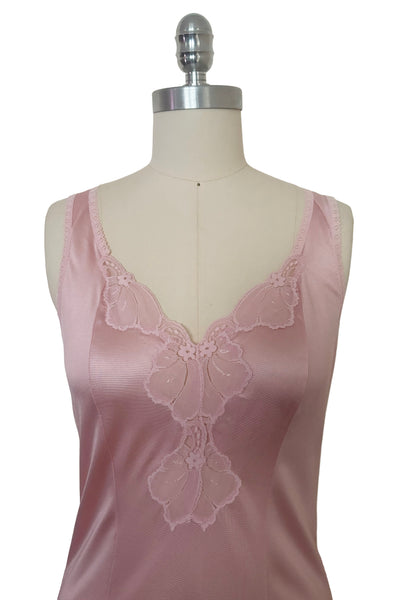 Bodice front view of 1970s vintage blush pink nylon tricot floral lace trimmed nightgown by Maidenform, size extra small to small. Showing the curved V-neckline, and princess seams.
