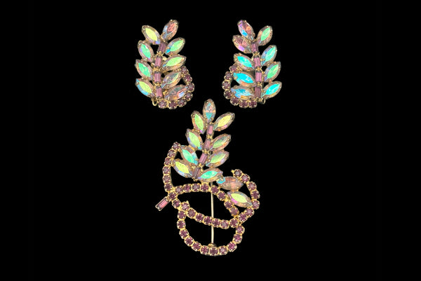 Horizontal front view of 1950s vintage iridescent and amethyst purple rhinestone leaf brooch and clip-on earring set.