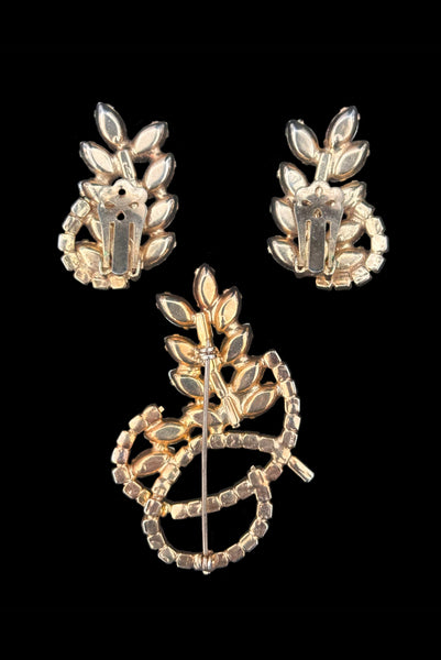 Vertical back view of 1950s vintage iridescent and amethyst purple rhinestone leaf brooch and clip-on earring set.