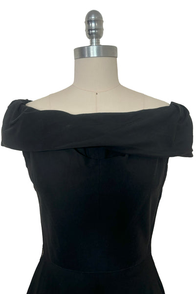 Bodice front view of 1950s vintage folded collar off the shoulder black dress with full skirt, size extra small to small.