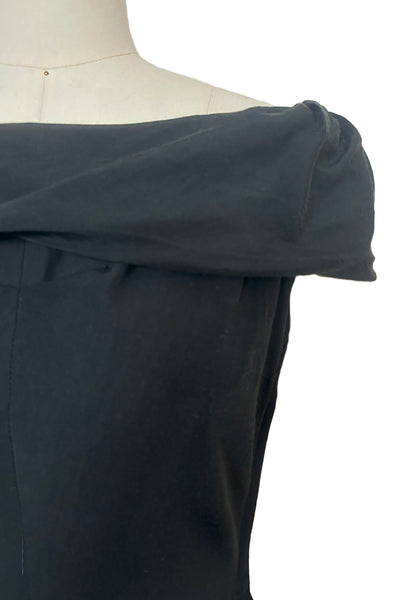 Detail view of 1950s vintage folded collar off the shoulder black dress with full skirt, size extra small to small. Showing the pleated bust.