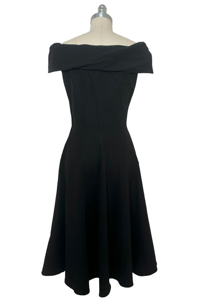 Back view of 1950s vintage folded collar off the shoulder black dress with full skirt, size extra small to small.