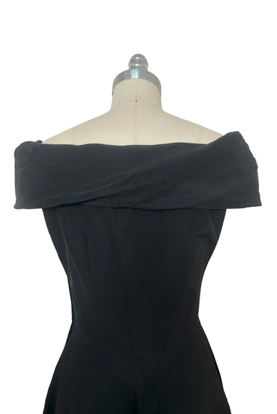 Bodice back view of 1950s vintage folded collar off the shoulder black dress with full skirt, size extra small to small.