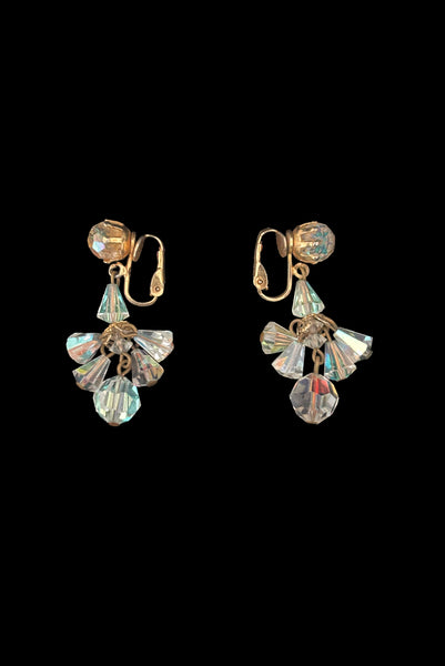 Vertical side view of 1960s vintage iridescent crystal bead and gold tone chandelier drop earrings.
