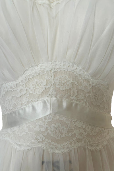 Detail view of 1940s vintage white nylon bridal lingerie ballerina nightgown by Vanity Fair, size small to medium. Showing the gathered bodice and lace and ribbon midriff.