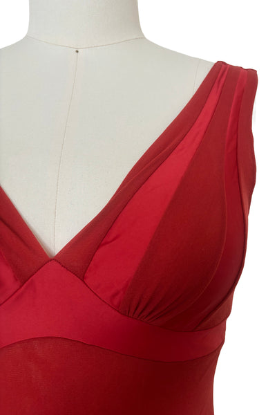 Detail view of new with tags 2000s y2k vintage deadstock ruby red mesh and satin, V-neck, sleeveless, empire waist top by On Gossamer, size medium to large. Showing the V-neckline, red satin panels, and empire waist.