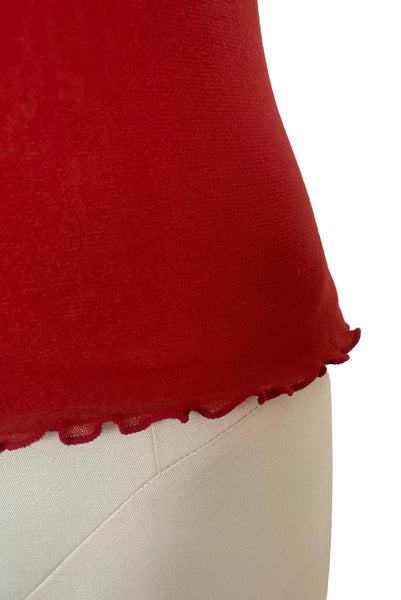Detail view of new with tags 2000s y2k vintage deadstock ruby red mesh and satin, V-neck, sleeveless, empire waist top by On Gossamer, size medium to large. Showing a close-up of the lettuce hem.