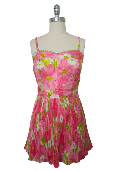 Front view of 1950s vintage pink, white, and chartreuse green watercolor floral print sweetheart neckline pleated skirt playsuit/mini dress by Gabar, size small to medium.