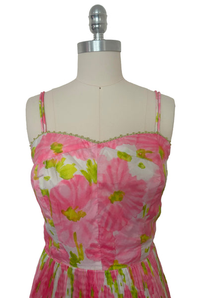 Bodice front view of 1950s vintage pink, white, and chartreuse green watercolor floral print sweetheart neckline pleated skirt playsuit/mini dress by Gabar, size small to medium.