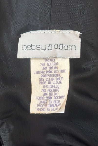 Interior detail view of 1990s vintage goth bat wing collar rhinestone trim evening dress by Betsy and Adam, size extra small to small. Showing the Betsy and Adam label, and fabric composition tag.