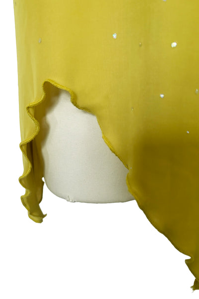 Detail view of 2000s y2k vintage chartreuse green asymmetrical halter neckline, handkerchief hem polyester knit mini dress with iridescent glitter by Kitty, size small to medium. Showing a close-up of the handkerchief hem.