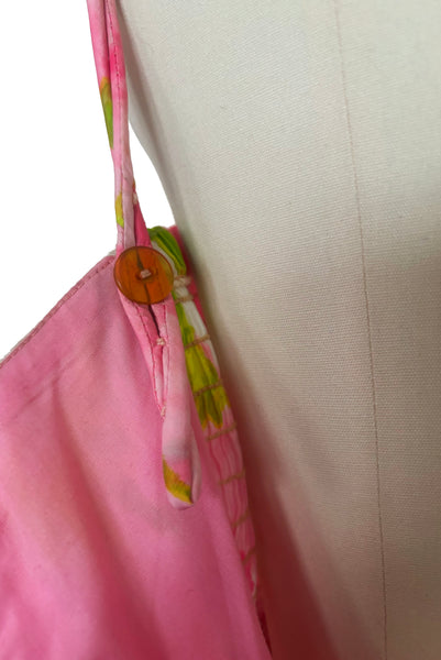 Interior detail view of 1950s vintage pink, white, and chartreuse green watercolor floral print sweetheart neckline pleated skirt playsuit/mini dress by Gabar, size small to medium. Showing the adjustable button straps.