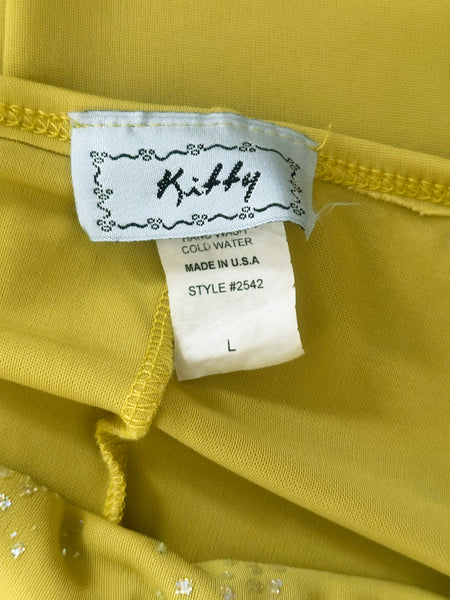 Interior detail view of 2000s y2k vintage chartreuse green asymmetrical halter neckline, handkerchief hem polyester knit mini dress with iridescent glitter by Kitty, size small to medium. Showing the kitty label and size L tag.