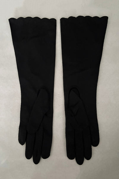 Vertical back view of 1950s vintage mid length black Reindoe Nylon scalloped cuff gloves with gold embroidery and silver beaded leaves by Van Raalte, size 7.