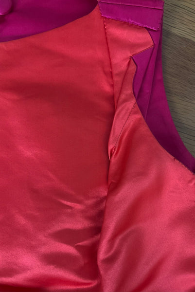 Interior detail view of 1960s vintage hot pink silk overblouse and brown silk chiffon two piece cocktail dress set, size extra small to small. Showing the interior construction details of the overblouse with the double sided hot pink and range silk satin. 