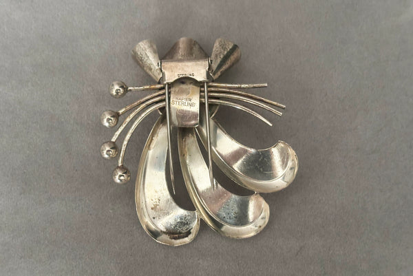 Horizontal back view of 1930s vintage 925 sterling silver rhodium plated Modernist botanical fur clip by Napier.