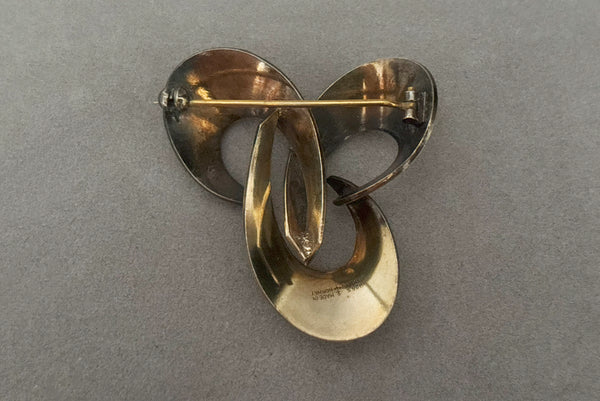 Horizontal back view of 1950s vintage Hans Myhre 925 sterling silver and white guilloche enamel brooch. Made in Norway.