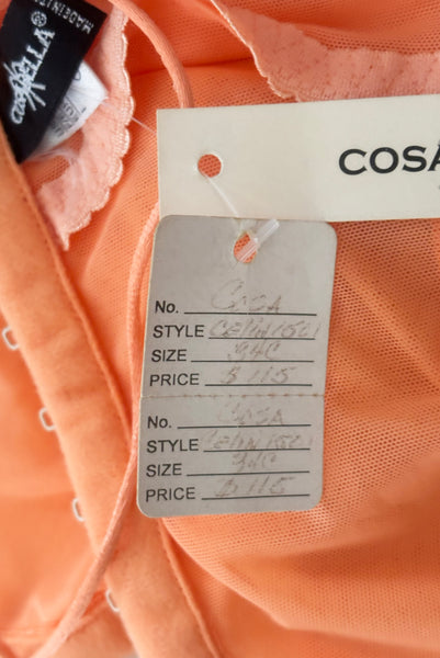 Interior detail view of 2000s y2k vintage, as is, new with tags creamsicle orange mesh and green lace underwire bustier with laced back by Cosabella, size extra small to small. Showing the paper shop tag with original price.