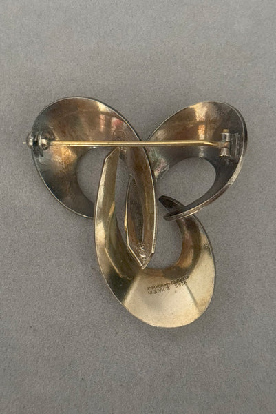 Vertical back view of 1950s vintage Hans Myhre 925 sterling silver and white guilloche enamel brooch. Made in Norway.