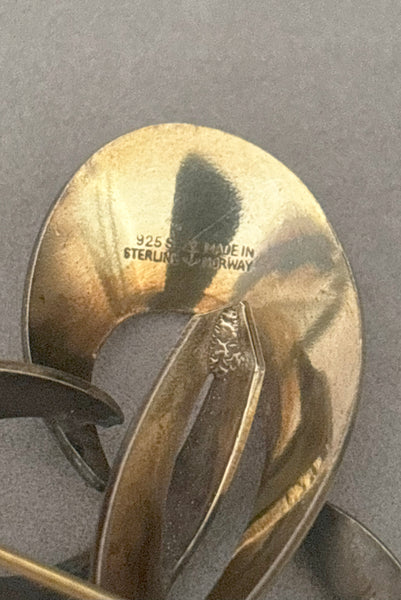 Detail view of 1950s vintage Hans Myhre 925 sterling silver and white guilloche enamel brooch. Made in Norway. Showing the 925S Sterling and Made in Norway stamps.