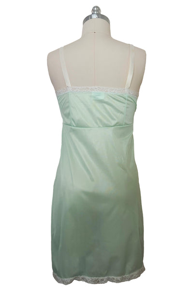 Back view of 1960s vintage pale mint green and white lace mini full slip by Philmade, medium to large.