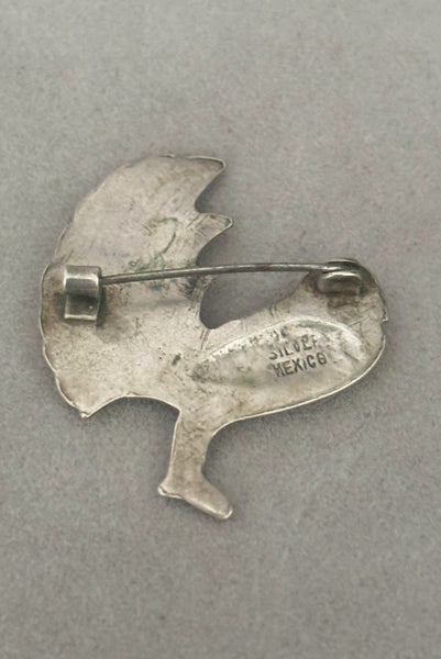 Detail view of 1930s vintage Mexican sterling silver pair of bird brooches. Showing the back of a single brooch with the Mexico and Sterling stamps.