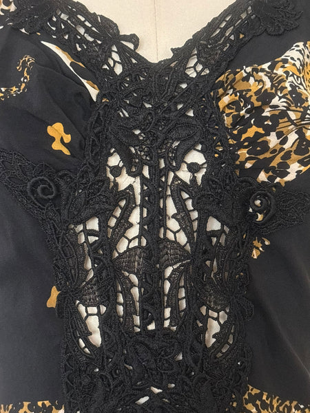 Detail view of 1990s vintage leopard animal print black silk and re embroidered lace camisole top by Sky, size extra small to small. Showing the lace at the sweetheart neckline and down the center front.