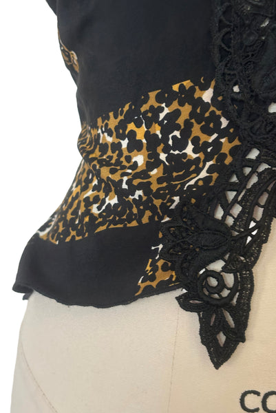 Detail view of 1990s vintage leopard animal print black silk and re embroidered lace camisole top by Sky, size extra small to small. Showing the lace detail at the hem.