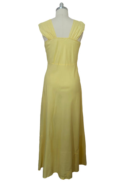 Back view of vintage 1940s yellow bias cut rayon and cream lace sweetheart neckline nightgown, medium to large. Wide straps and ankle length skirt.