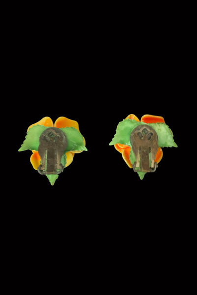Vertical back view of 1950s vintage orange and green plastic rose clip-on floral earrings.