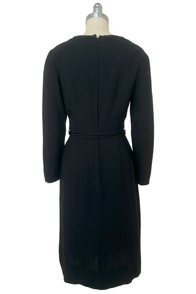 Back view of 1950s vintage long sleeve, V-neck black crepe wiggle dress with triple stand self tie belt, by R&K Originals, small to medium.