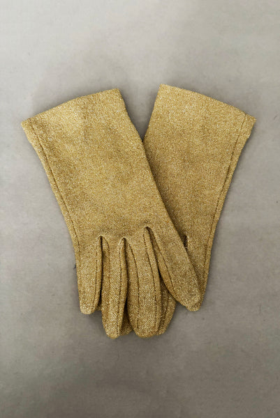 Vertical pair view of 1950s vintage wrist length stretchy metallic gold nylon mylar gloves with clear rhinestone buttons.