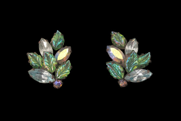 Horizontal front view of 1950s vintage iridescent teal blue green pressed glass and marquise rhinestone leaf clip-on earrings.
