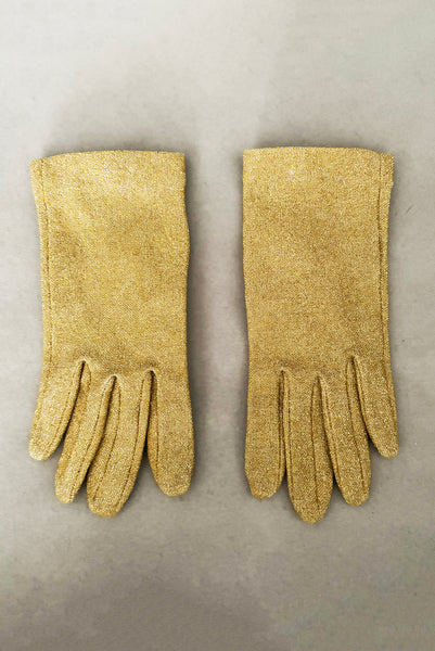 Vertical front view of 1950s vintage wrist length stretchy metallic gold nylon mylar gloves with clear rhinestone buttons.