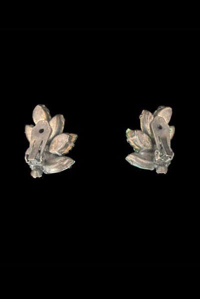 Vertical back view of 1950s vintage iridescent teal blue green pressed glass and marquise rhinestone leaf clip-on earrings.