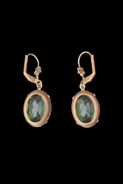 Vertical back view of 2010s vintage faceted glass oval peridot green rhinestone and brass lever back drop earrings made from vintage components.