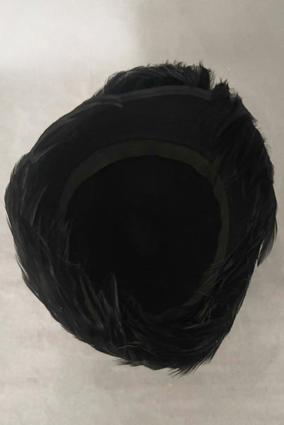 Vertical interior view of 1960s vintage jet black feather and felt casque hat.