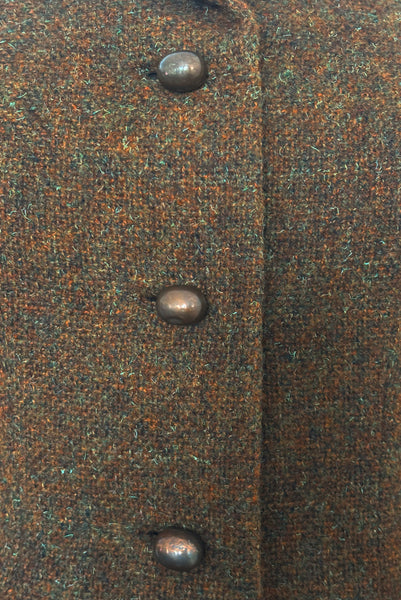 Detail view of 1960s vintage rust brown wool, three copper metal button, long sleeve jacket by Pauline Trigère for Bergdorf Goodman, size medium to large. Showing discoloration to the copper colored buttons and a small dent in one.